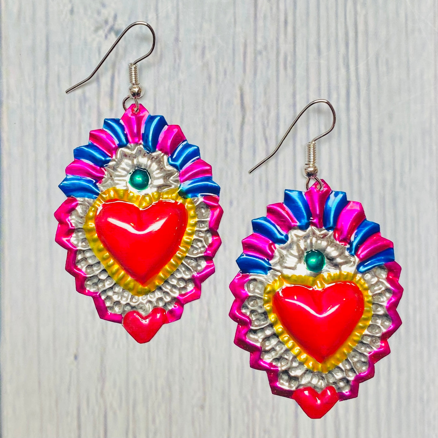 Colorful tin sacred heart earrings.