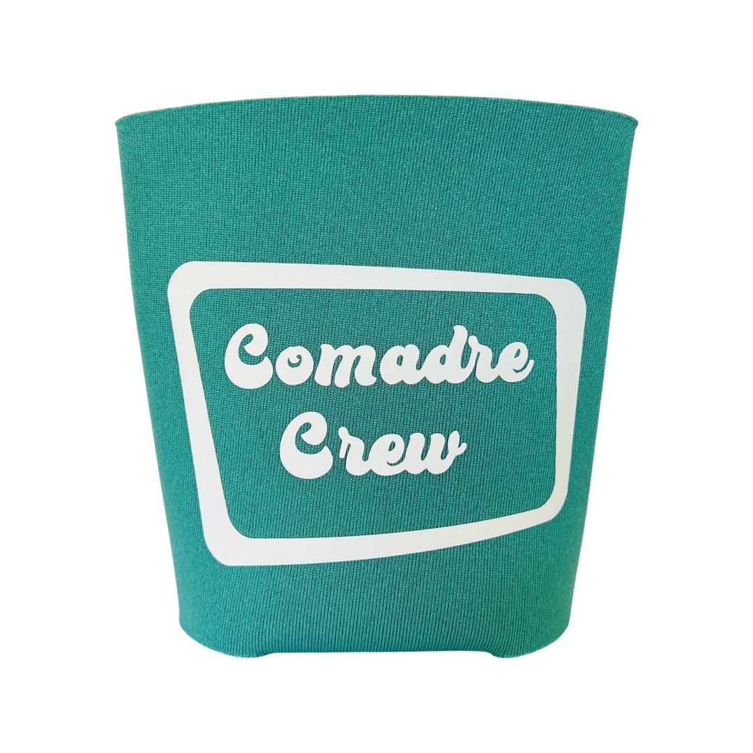 Teal can cooler with the phrase Comadre Crew in white lettering
