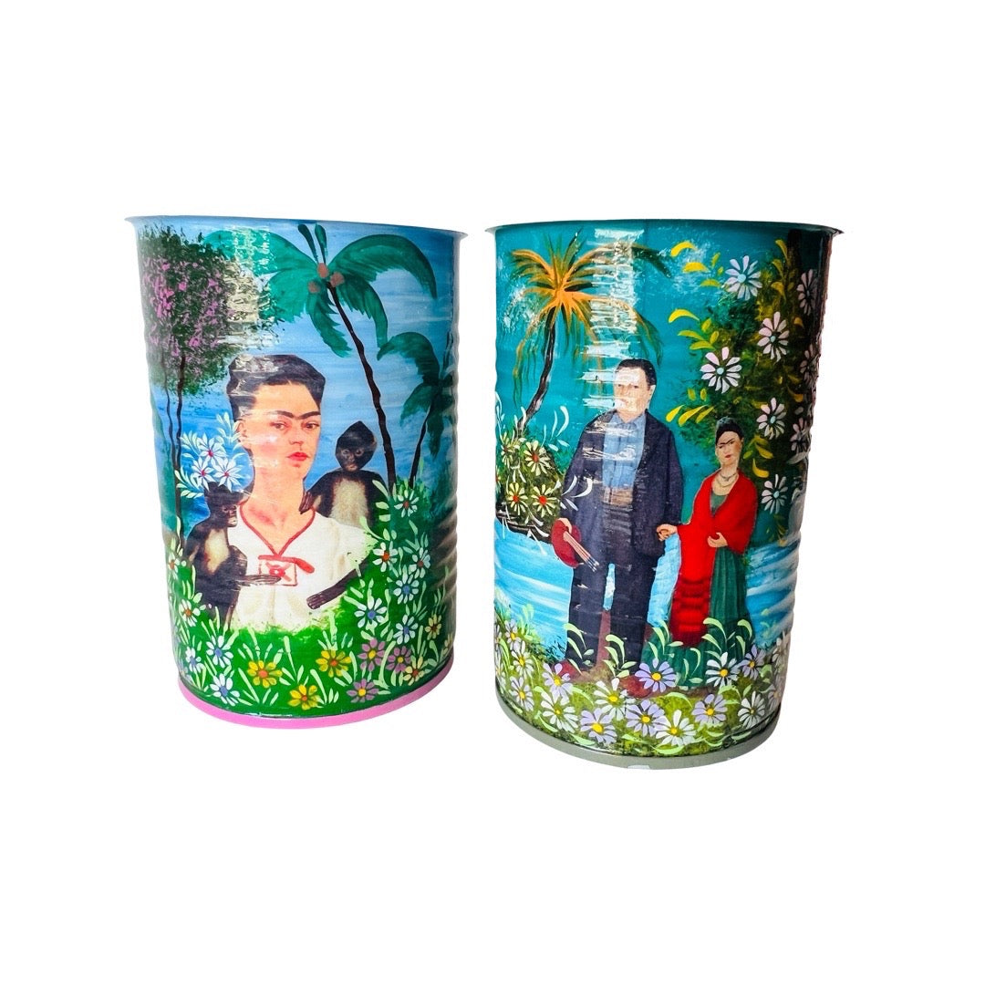Hand painted Frida cans. First can features portrait of Frida with monkeys and second can features Diego and Frida holding hands. 