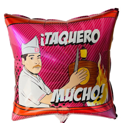 Square pink balloon that reads, "¡Taquero Mucho!" Balloon graphic features taquero (taco maker) winking and preparing tacos.