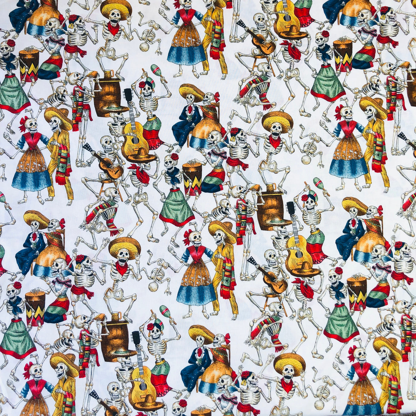 Alexander Henry Fabrics in Fiesta de los Muertos pattern. This pattern has multiple skeletons partying against a white background