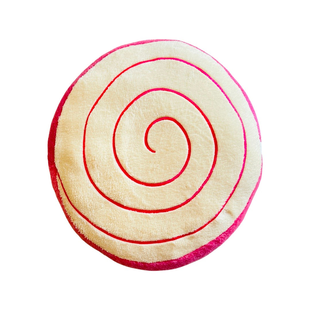 Plush jelly roll (pan dulce) pillow with pink and white accents.