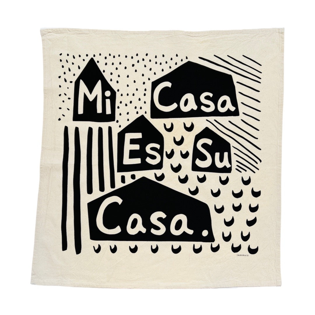 Cotton, "Mi Casa Es Su Casa" phrase kitchen towel with black and white accent colors.