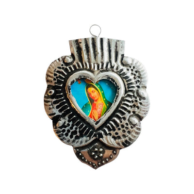 Rounded tin Sacred heart frame with image of the Virgen de Guadalupe in the center.