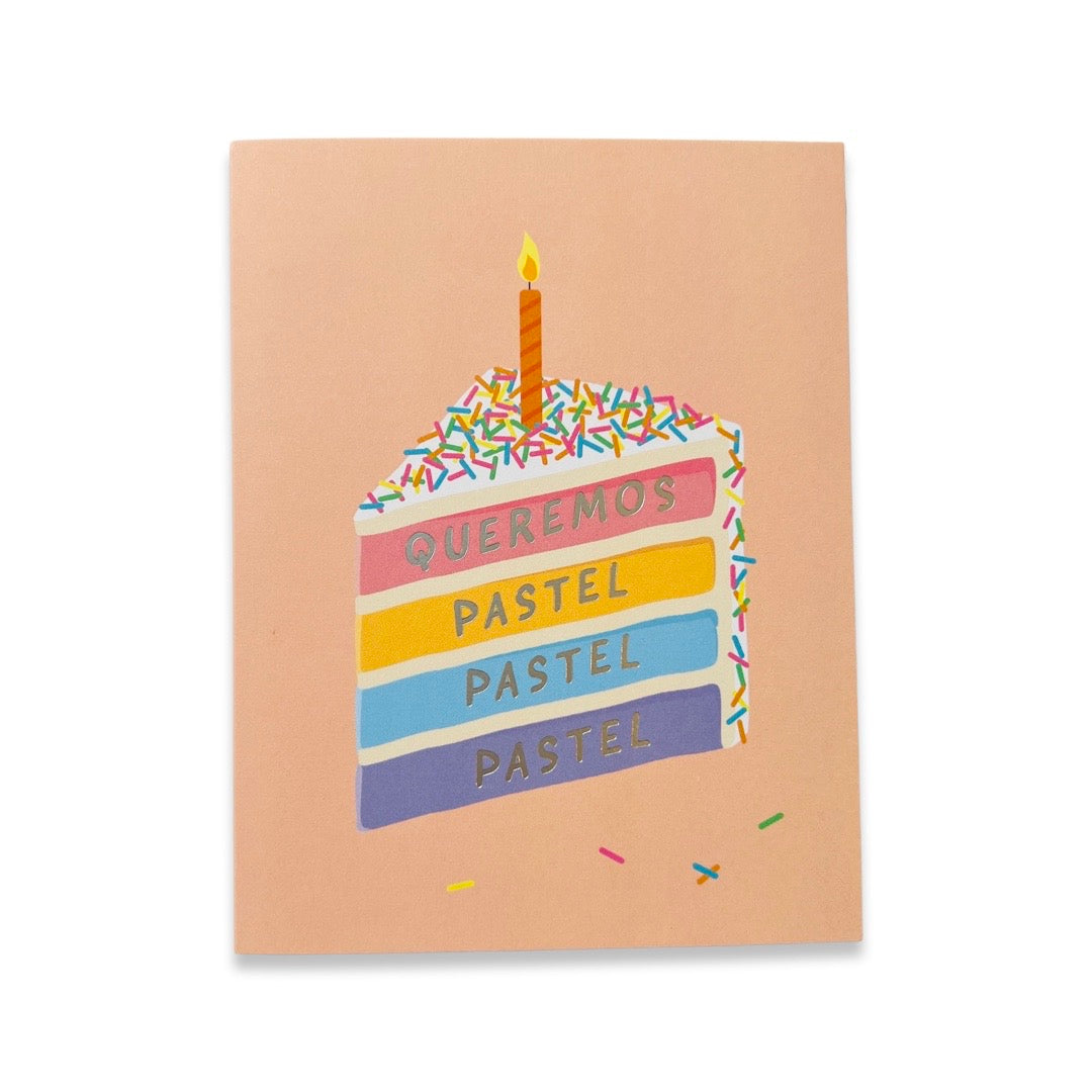 Queremos Pastel birthday card. Design features colorful slice of cake with rainbow sprinkles and candle.