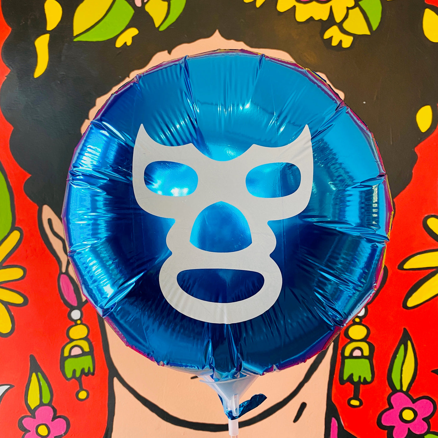 Blue circular Luchador balloon. White accent color on mask.