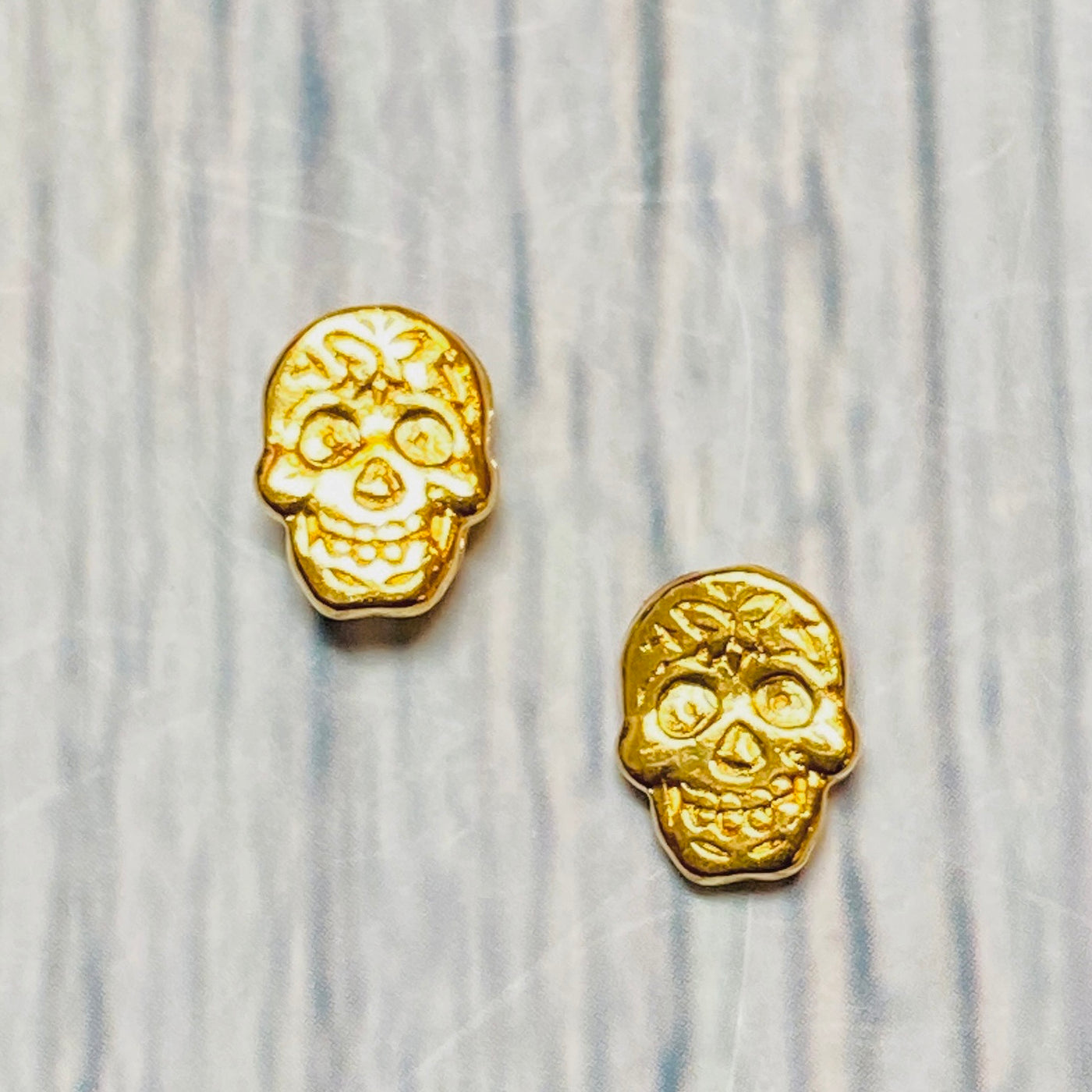 Gold plated brass sugar skull post earrings.