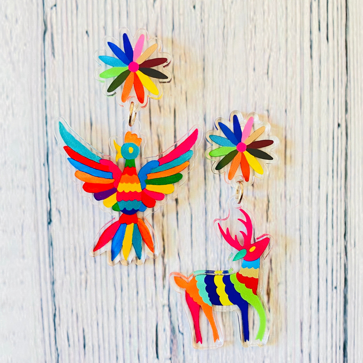 Handmade acrylic Otomi earrings featuring bird and dear.