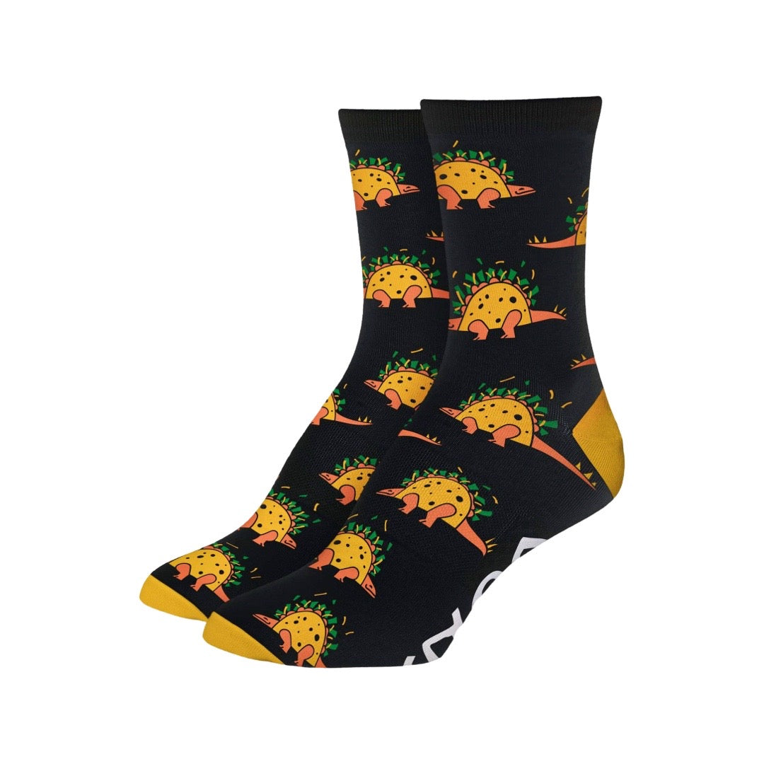 A pair of black socks with orange, yellow and green dinosaur that has a body of a taco; a tacosauras.