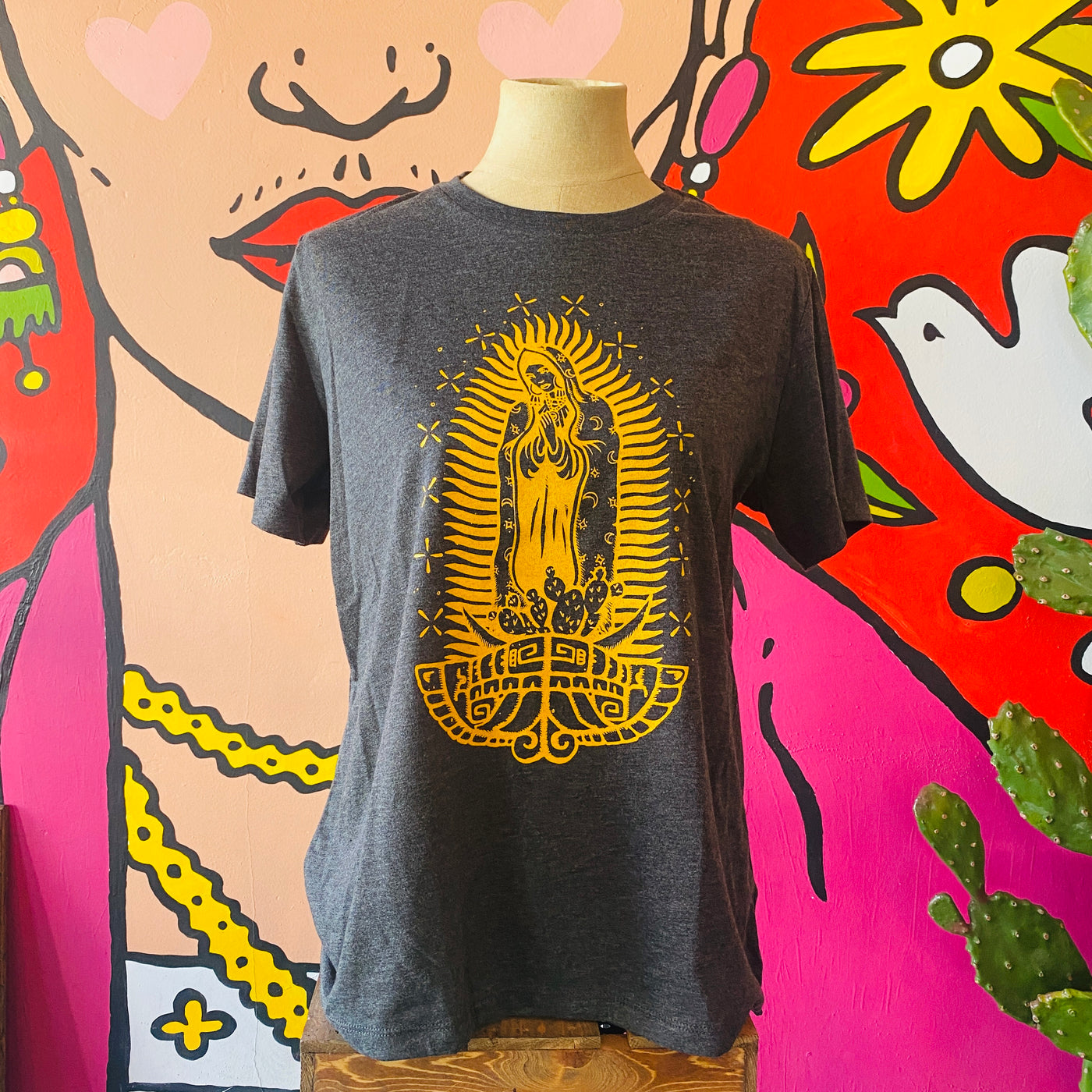 Gray Virgencita t-shirt with yellow detail pictured on mannequin. 