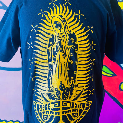 Close up of black Virgencita kid's shirt with yellow accent color.