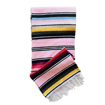 Light pink serape striped blanket folded in half.