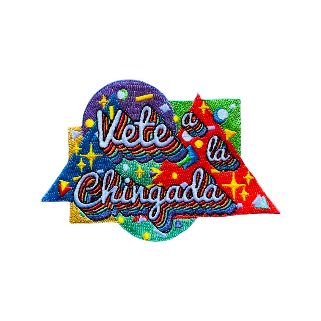 Colorful geometric shapes with the words "Vete a la chingada" in rainbow lettering surrounded by gold stars.