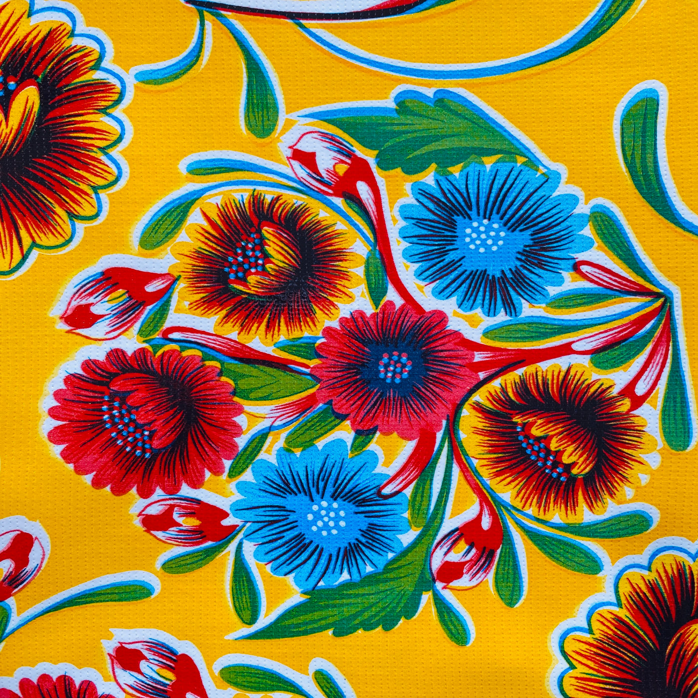 Yellow bloom oilcloth table cover. Design features colorful flowers. 