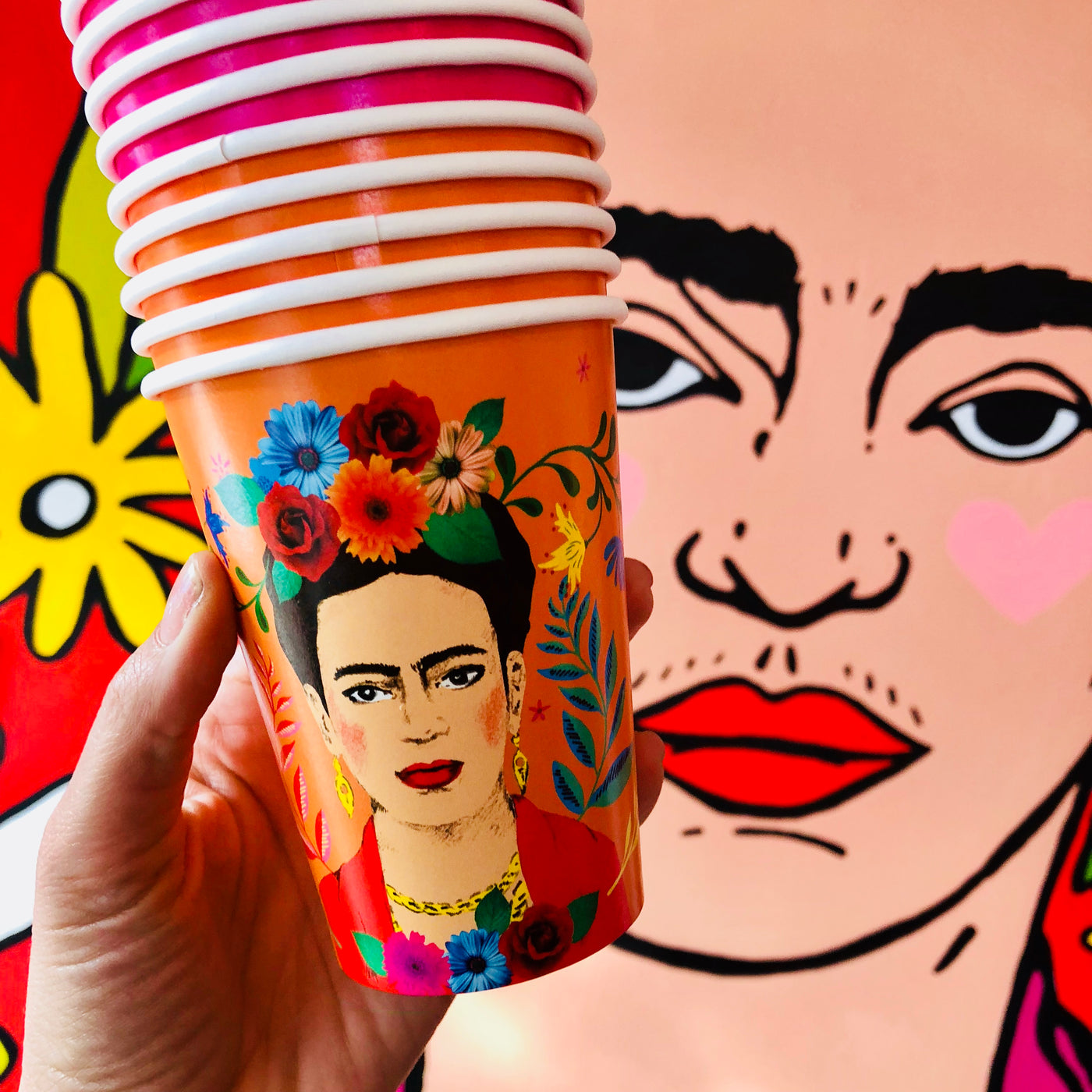 Stack of orange floral Frida Kahlo paper cups