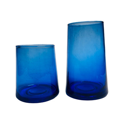 Blue glass tumblers. Image features two tumblers to compare sizes and variability of glass design.