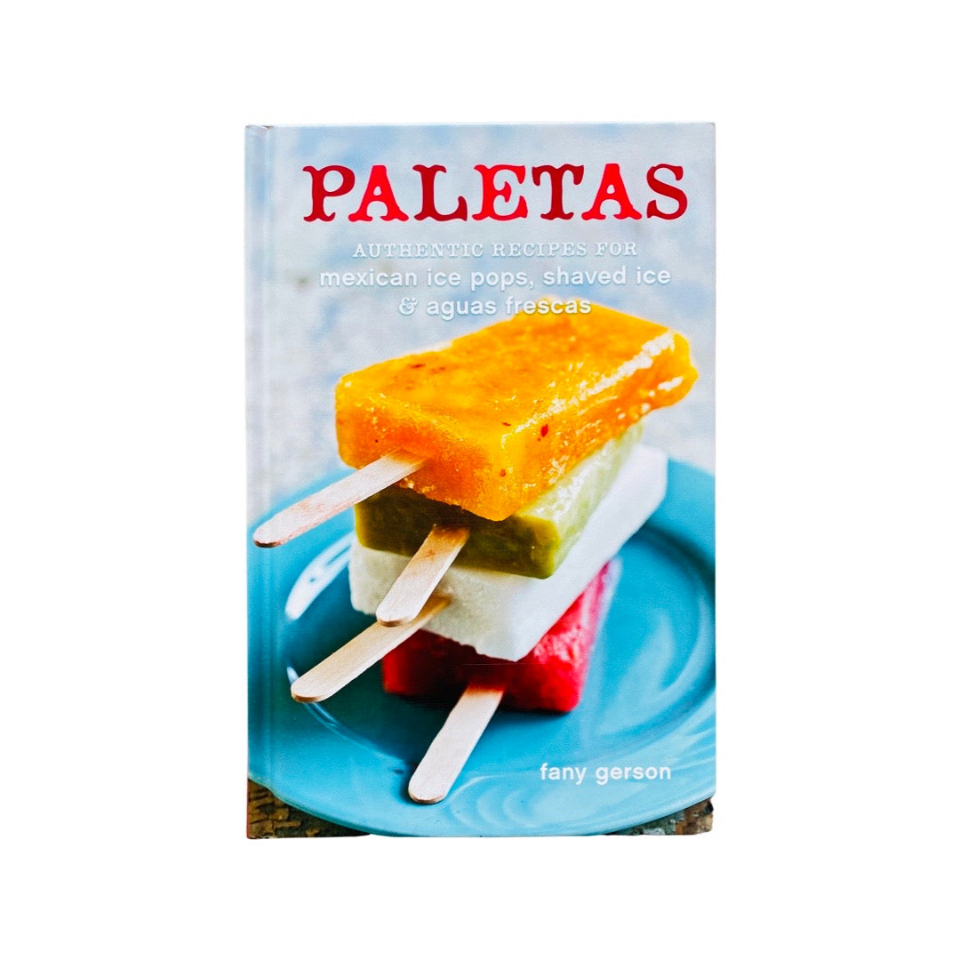 Front cover of Paletas cookbook. Image features 4 colorful paletas stacked on top of each other served on a blue plate. 