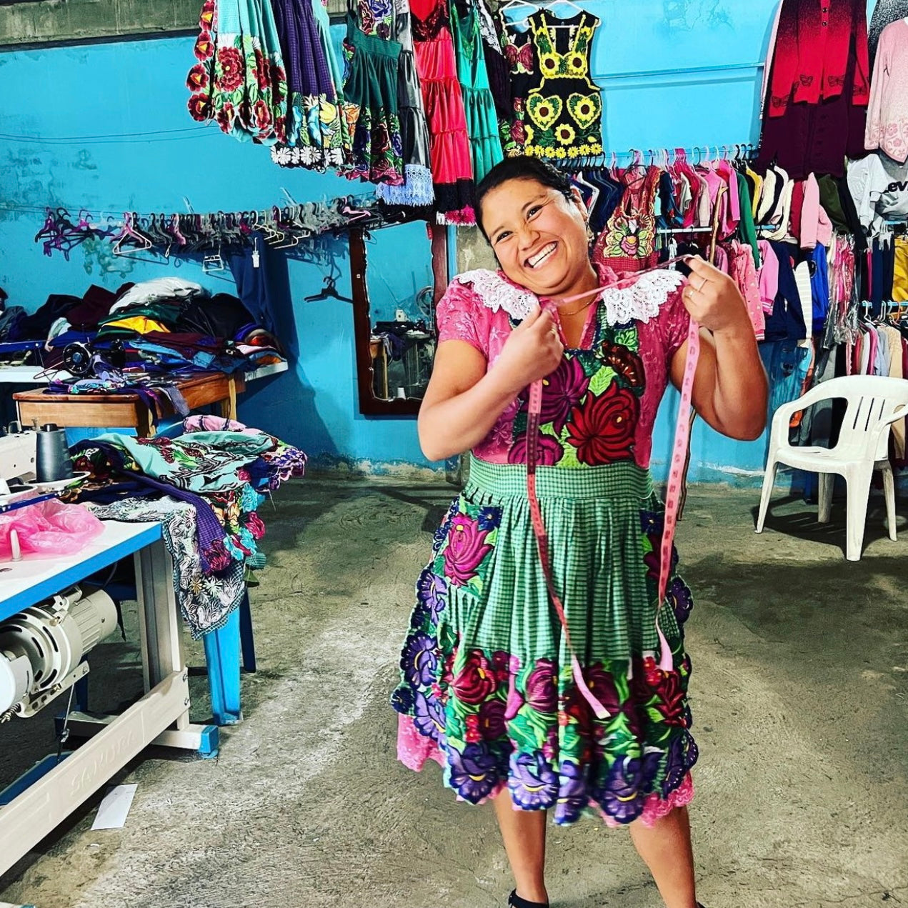 Maria Zacarias of San Miguel del Valle wearing one of her handmade embroidered aprons in green.