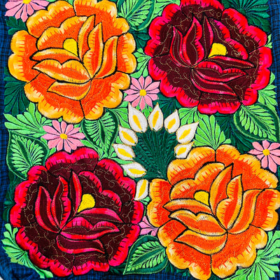 Close up view of orange and red flowers embroidered on the front of the tote bag.