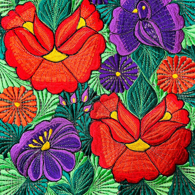 Close up view red and purple flowers on front of tote bag.