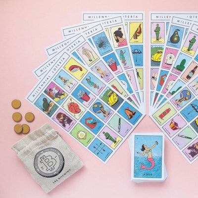 Top view of Millennial Loteria set: card deck, bingo boards, and bitcoin tokens.