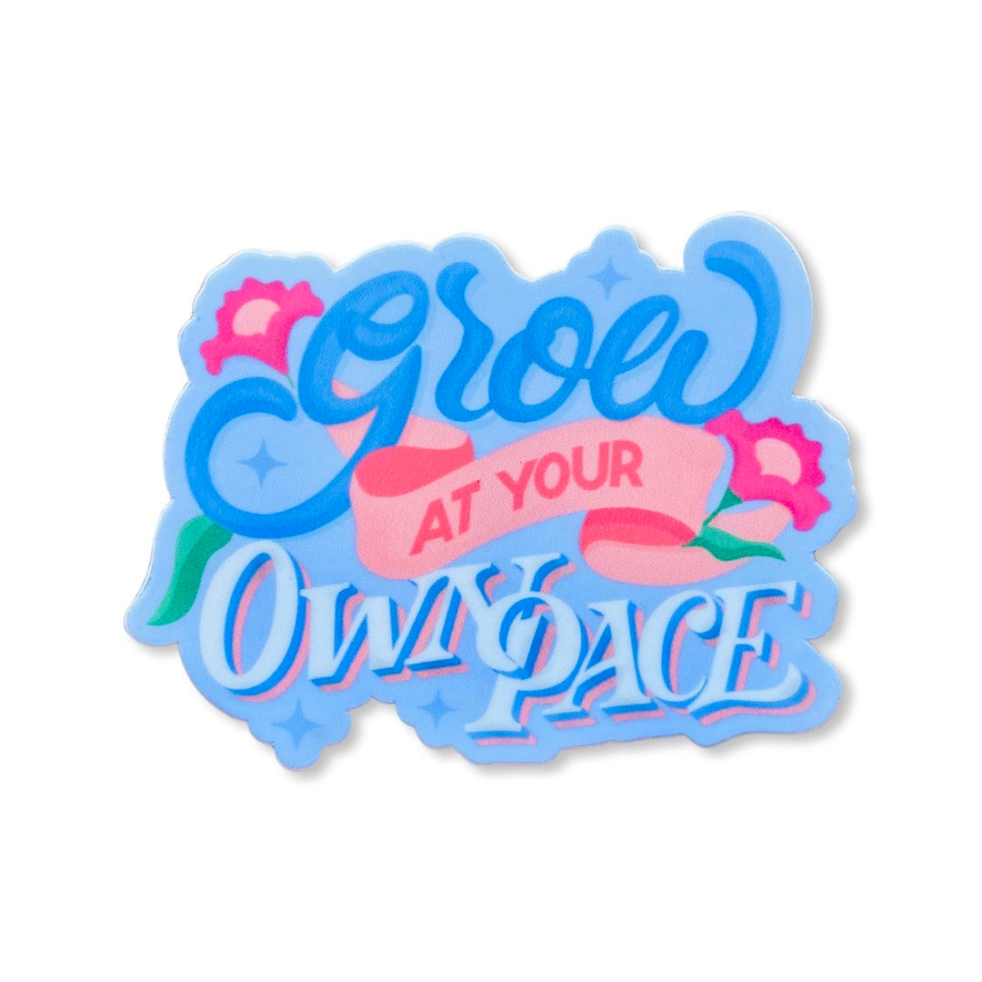 Grow At Your Own Pace phrase sticker. Design features pink flowers.