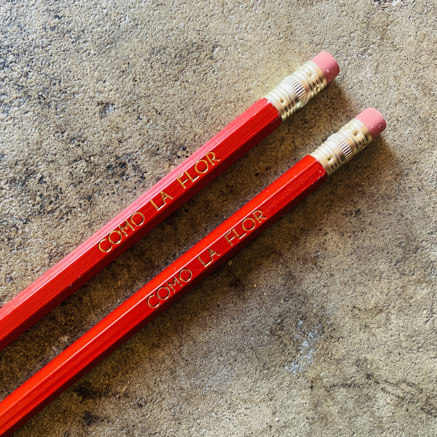 Como La Flor phrase pencils in red.
