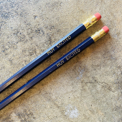 Muy Excited phrase pencils in dark blue.