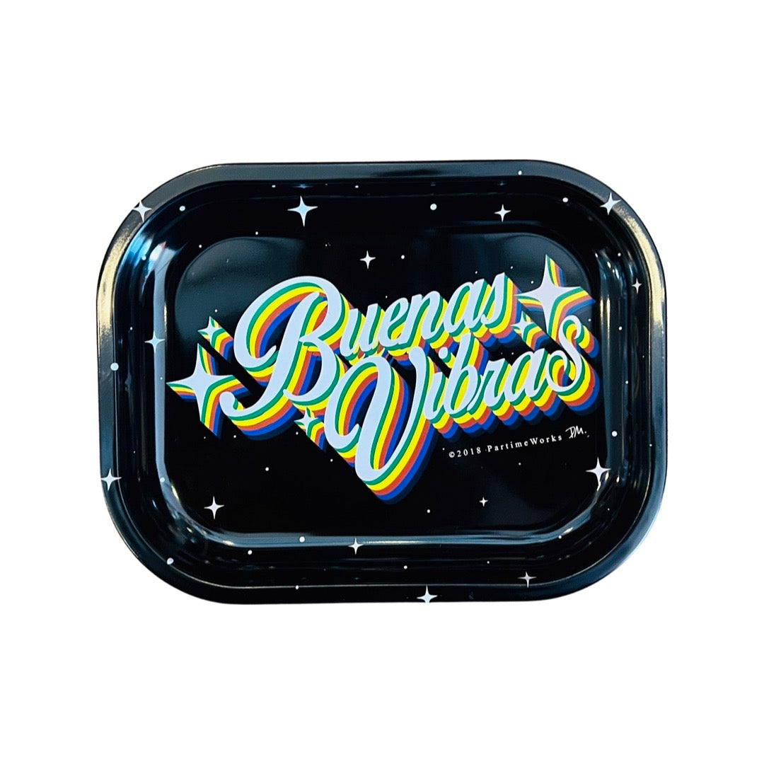 A rectangular metal tray that features the phrase Buenas Vibras, which is Spanish for Good Vibes, with black, yellow, orange and blue lettering. Tray is black with white stars scattered throughout the design.