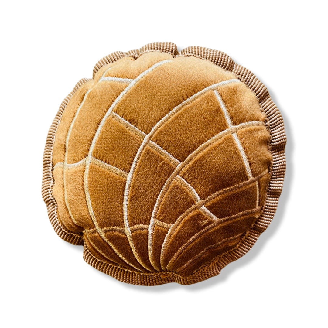 Brown round concha (sweet bread) dog toy.