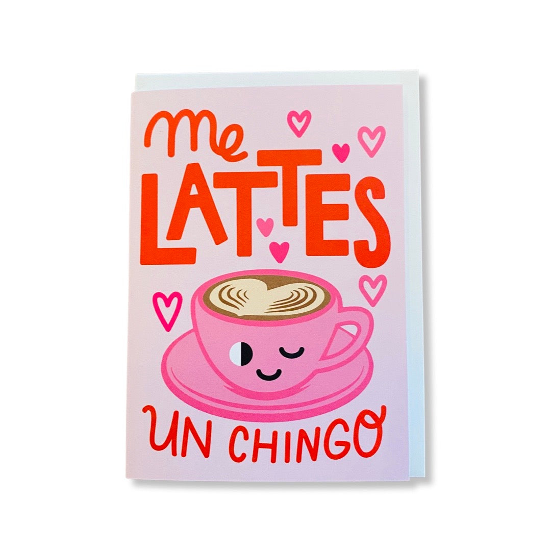Light pink card with a pink cup of latte with a smiley face and the phrase Me Lattes Un Chingo. Translation: I love you a lot