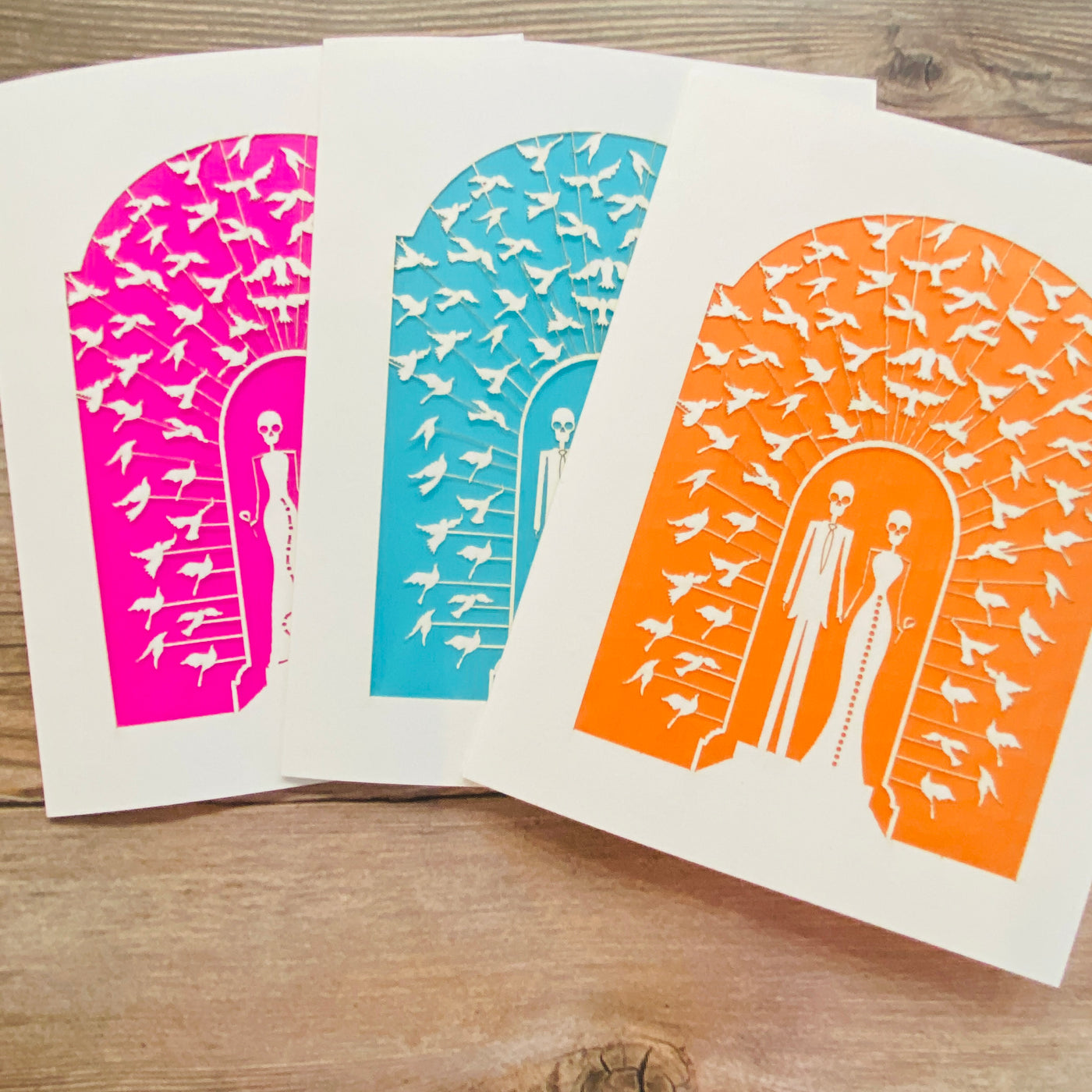 Wedding couple papel picado greeting cards in pink, blue, and orange.