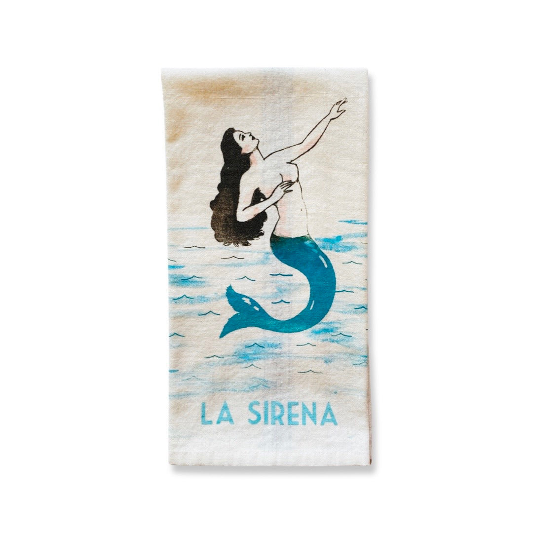 Loteria Dish Towel with la sirena (mermaid) phrase and image. Dish towel color is natural with blue and black accents. 