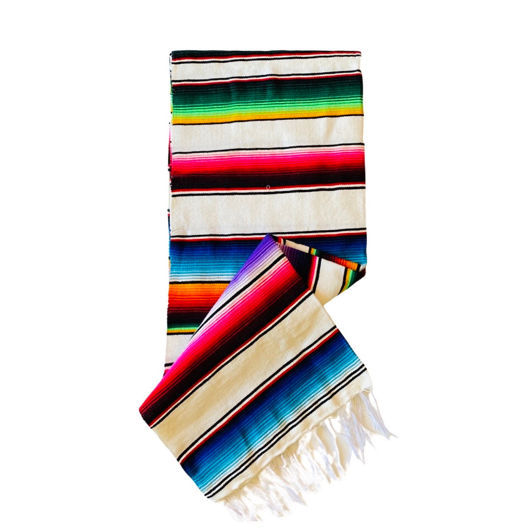 White serape striped blanket folded in half.