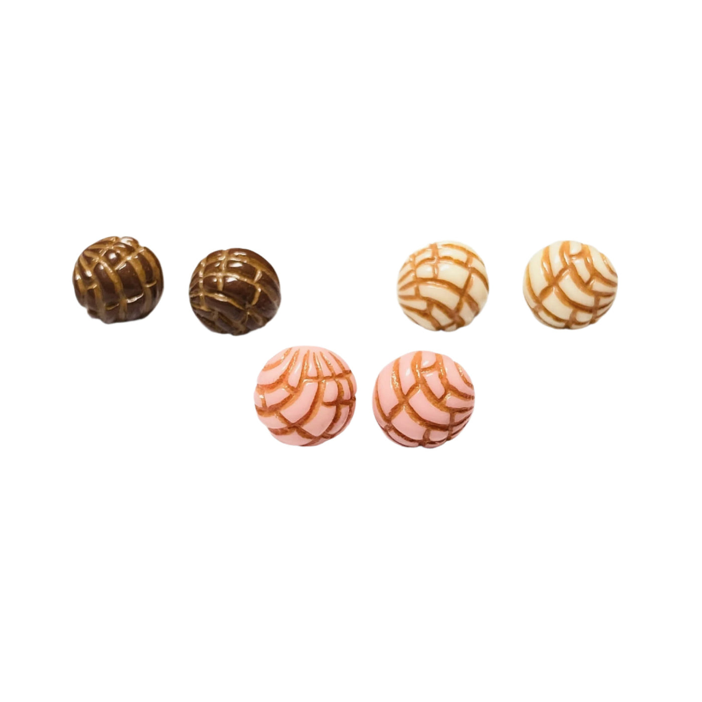 Trio of concha (type of sweet bread) stud earrings in brown, white, and pink.
