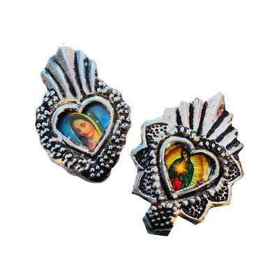 Silver heart-shaped pendant with detailed silver border and central image of a religious figure.