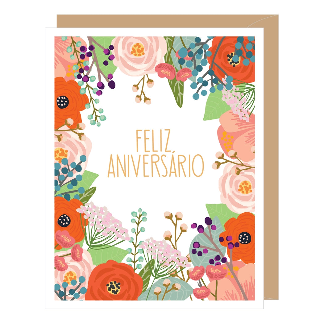 Feliz Aniversario (Anniversary) greeting card with colorful floral design. Feliz Aniversario is in the middle of card surrounded by floral trim/border.
