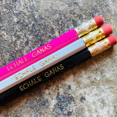 Pink, white, and black phrase pencils read, "Echale Ganas (give it all you got)."
