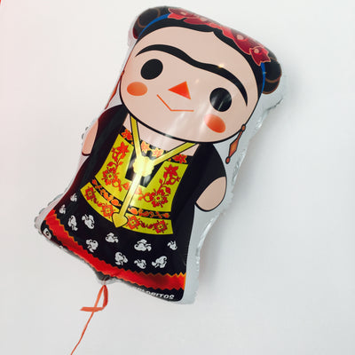 Top view of Frida Kahlo balloon. Frida has a Maria doll style appearance. Main colors featured are red, black, and yellow. Frida wears a red flower crown and traditional dress.