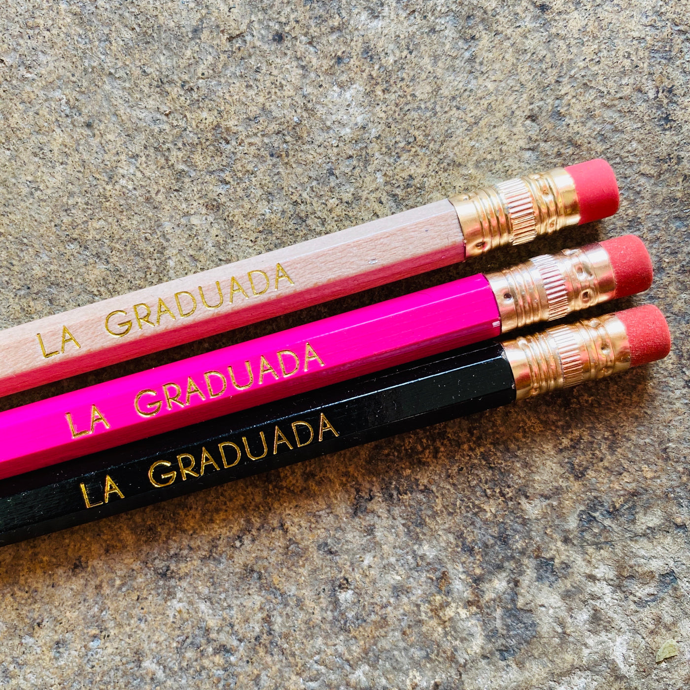 La Graduada phrase pencils featured in natural, pink, and black.