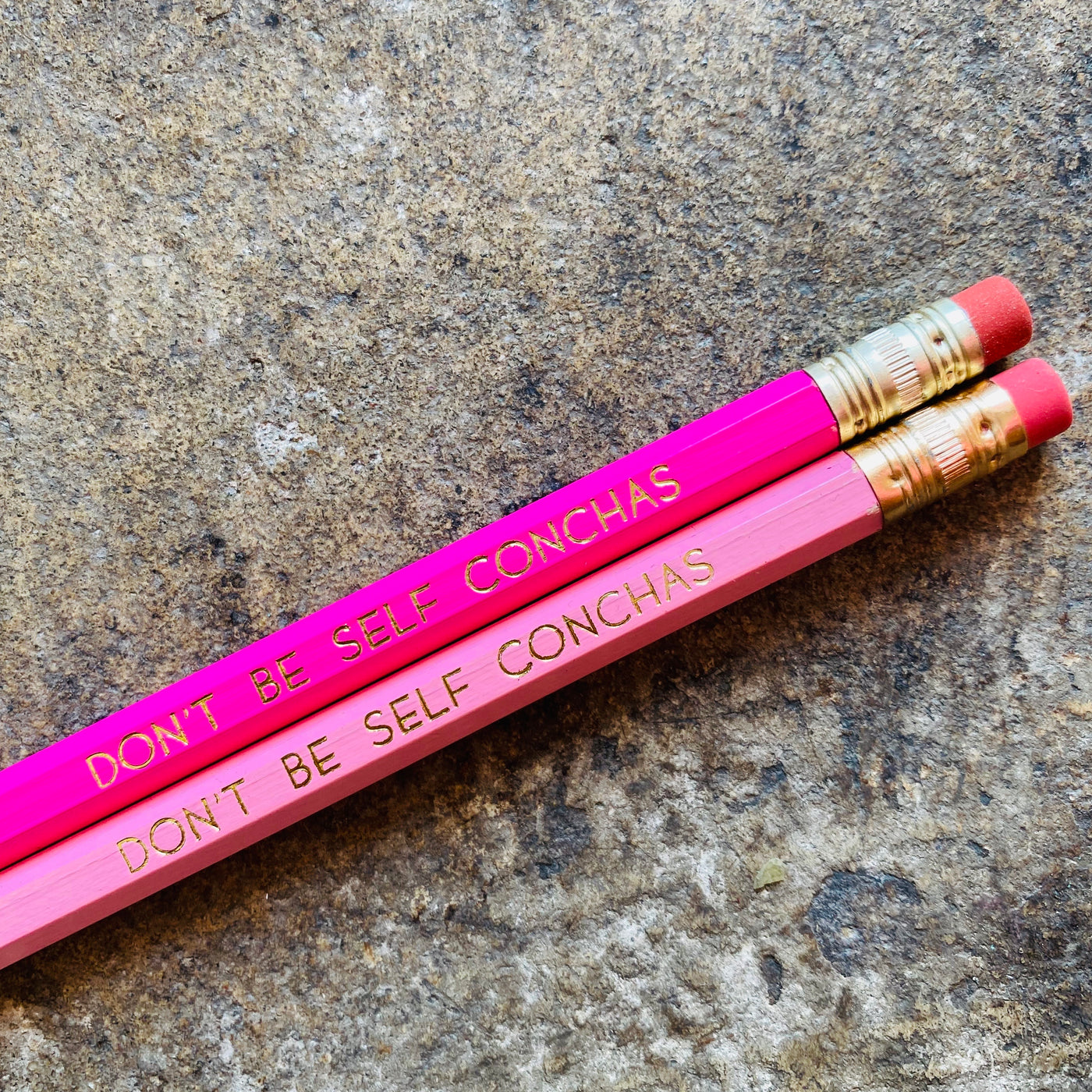 Don't Be Self Conchas phrase pencils in bright pink and light pink.