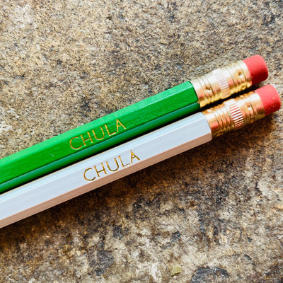Green and white Chula pencils.