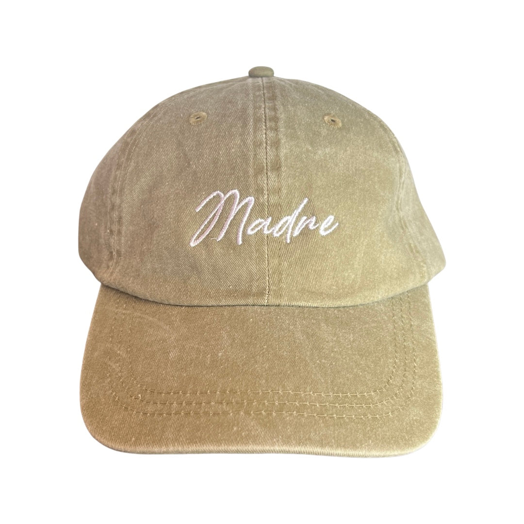 khaki hat with the word Madre in white lettering
