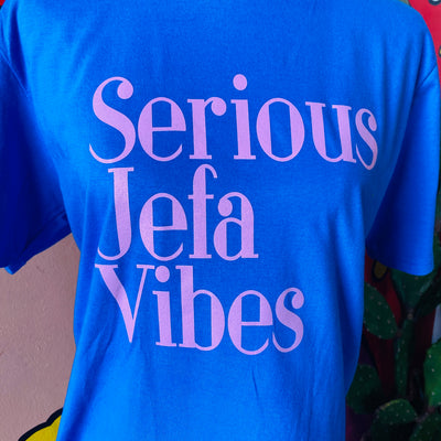 Close up of Royal Blue, "Serious Jefa Vibes" t-shirt with pink lettering.
