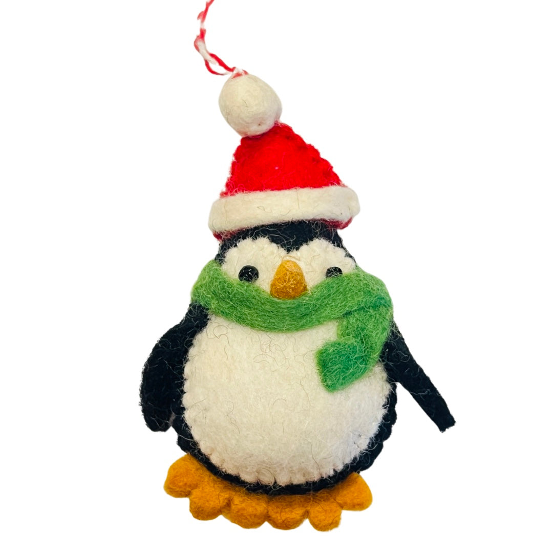 Felt penguin ornament wearing a green scarf and Santa hat.