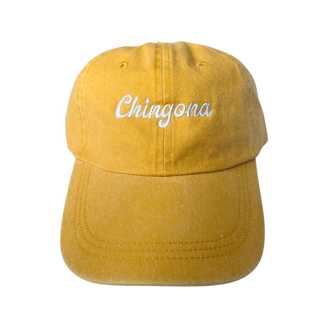 Mustard canvas hat with the phrase Chingona in white embroidered lettering.