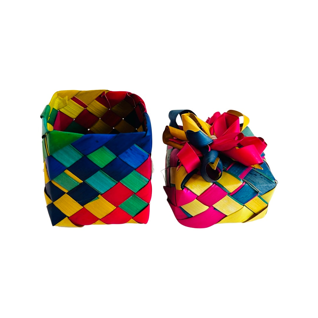 A single multi-colored palm leaf woven basket with a bow on the lid.