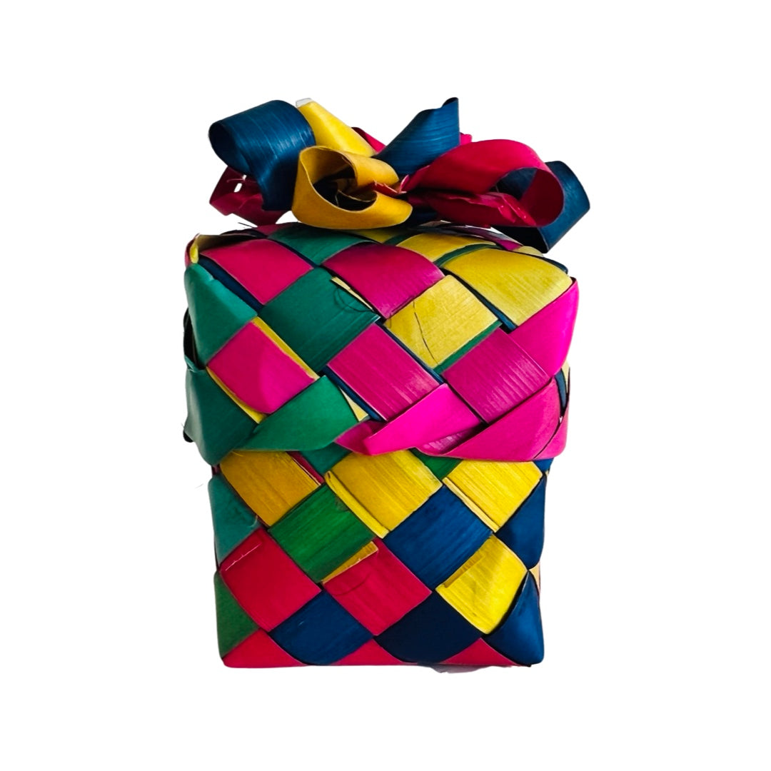 A single multi-colored palm leaf woven basket with a bow on the lid.