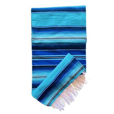 Blue and teal serape striped blanket folded in half.