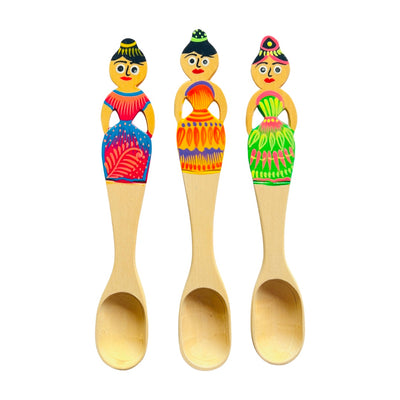 Large colorful Oaxacan painted wooden spoons featuring women in a colorful dress.